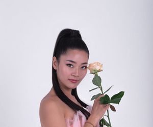 A person sitting in a meditative pose with eyes closed, embodying tranquility.